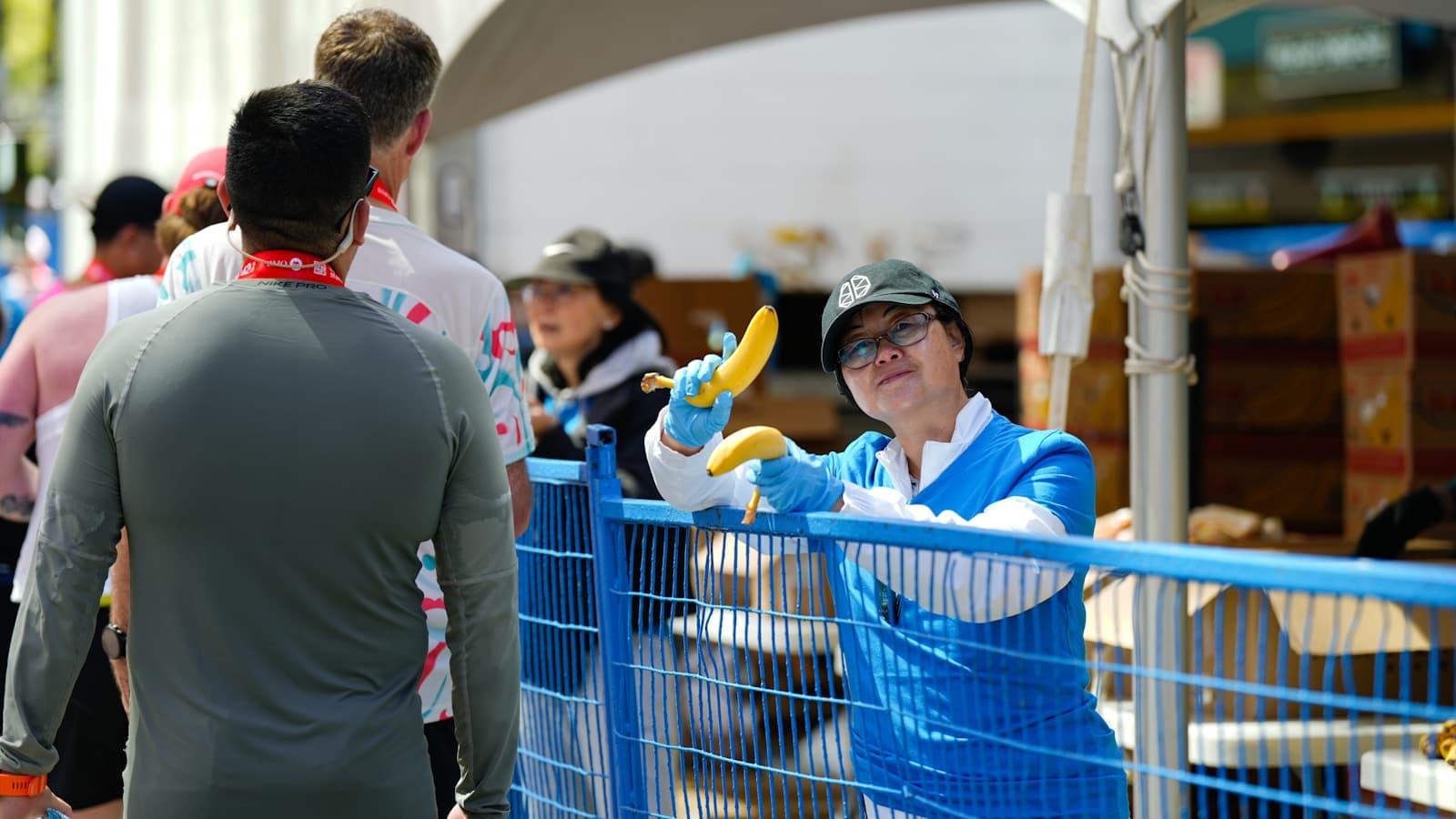 レース会場でランナーにバナナを手渡すボランティア